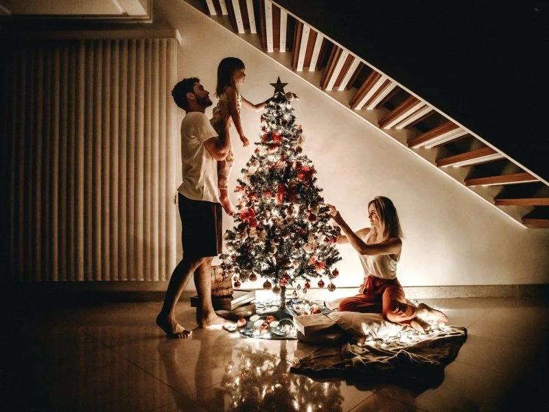family decorating their christmas tree