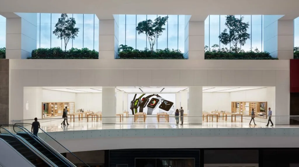 A modern Apple Store entrance with a large glass facade and a prominent Apple logo. A modern Apple Store entrance with a large glass facade and a prominent Apple logo.
