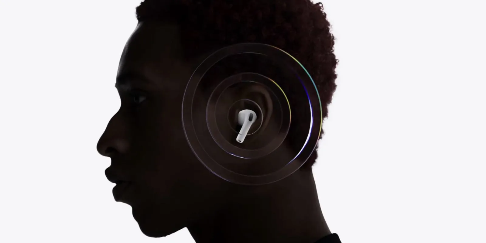 A person wearing headphones, with a smartphone displaying the Google Translate app interface.